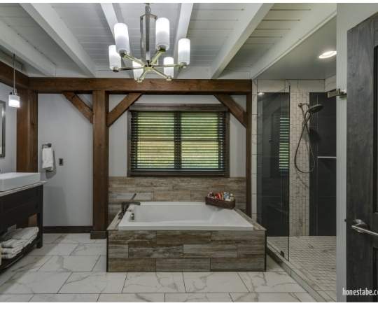 Photo of a contemporary soaker tub and walk in shower with stone flooring and painted wood ceiling