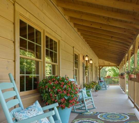 photo of covered porch with rows of rocking chairs.