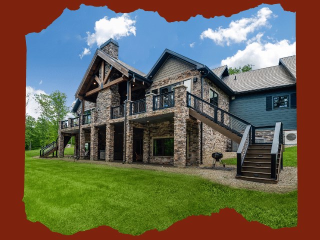 Photo of timber frame estate home with ground level patio and upper outdoor living space with expansive deck and covered porch area.